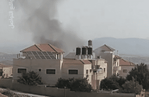 Smoke rises from a house, besieged by Israeli occupation forces in Jenin.